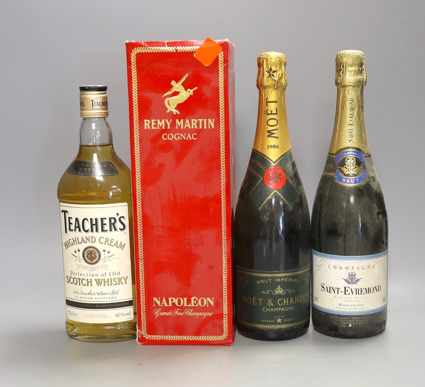 One bottle of 1986 Moët and Chandon Brut champagne, together with a bottle of Saint-Evremond champagne, a 70cl bottle of Teacher’s Highland Cream scotch whisky, and a boxed bottle of Remy Martin Cognac (4)